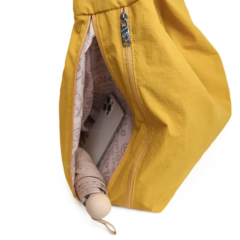 Soft nylon women's underarm bag in a heart shape, shown in black, blue, khaki, and yellow colours.