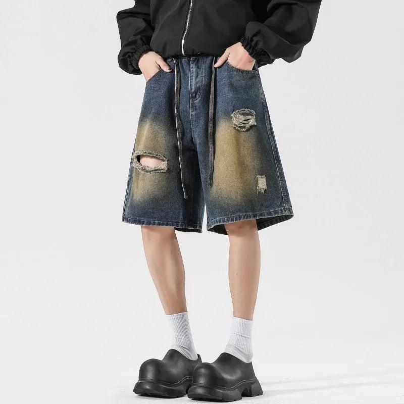 Men's loose fit ripped jeans in retro blue denim with distressed detailing and street style design