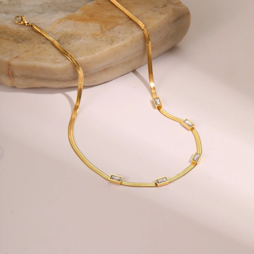 Stainless steel geometric square zircon necklace on a flat snake chain in gold or steel colour.