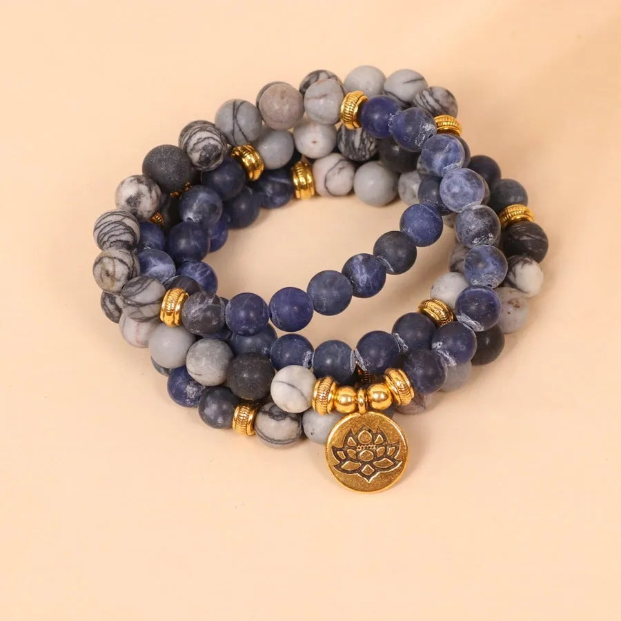 Blue patterned network stone beads on a multi-layer alloy bracelet in a natural style.