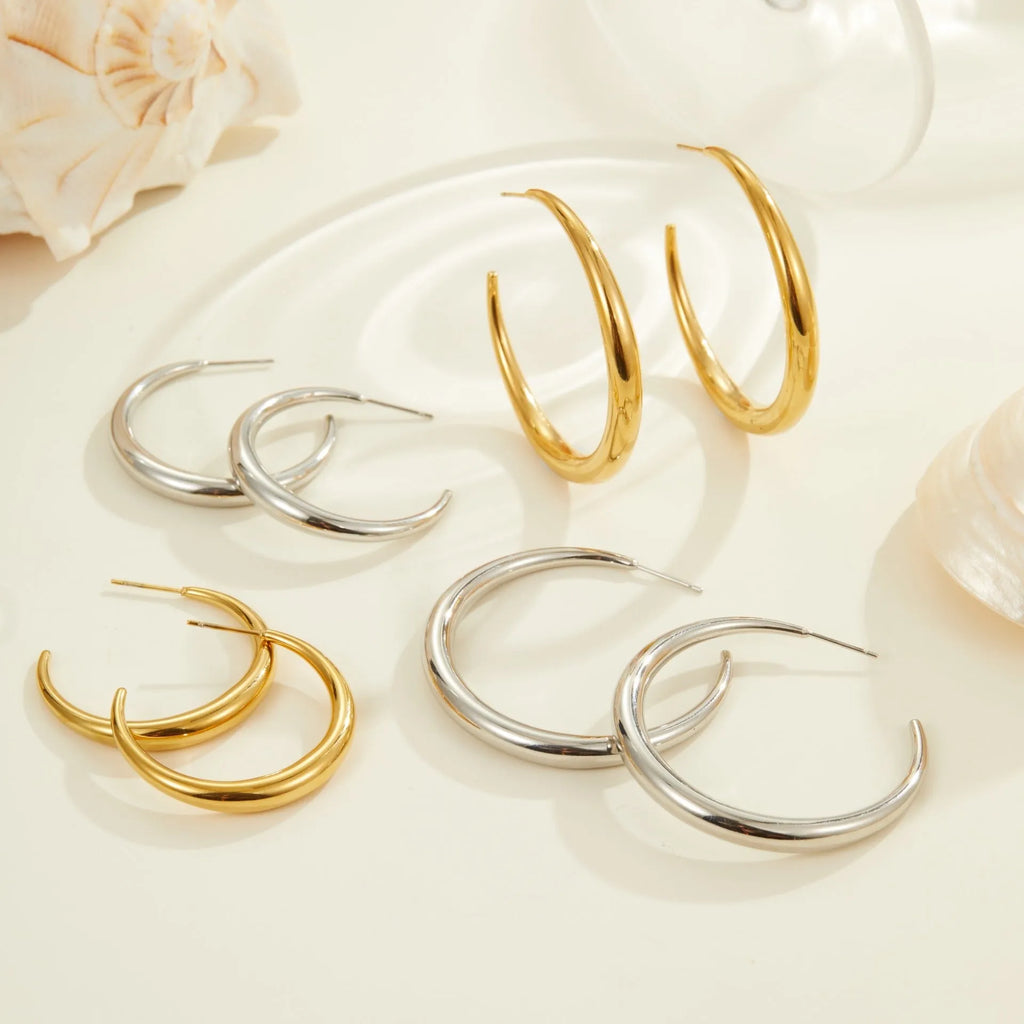 Titanium steel hoop earrings in geometric round design with gold and steel finish options