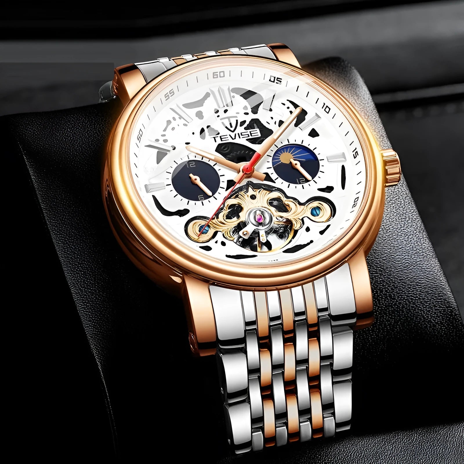 Men's black dial mechanical watch with visible golden tourbillon complication and luminous hands on a metal bracelet.