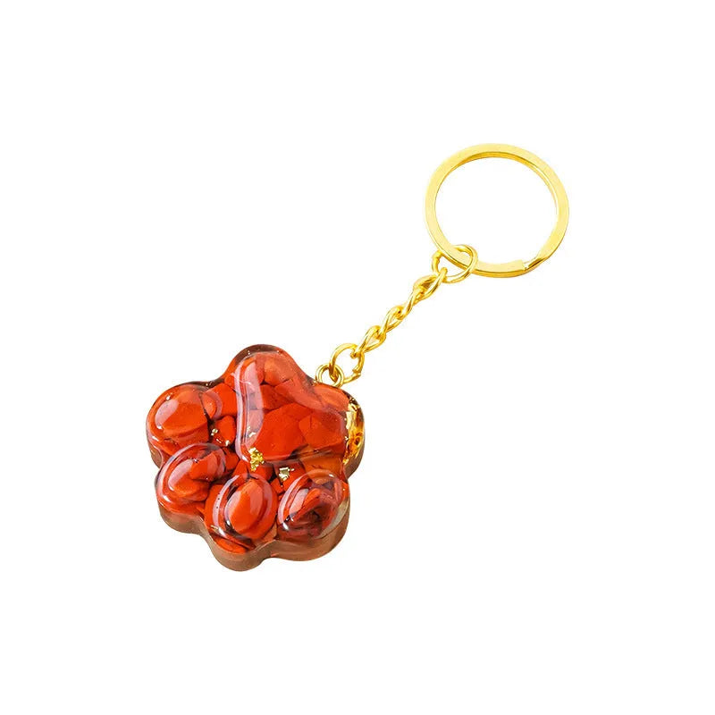 Small natural crystal cat's paw charm on a metal keyring loop.