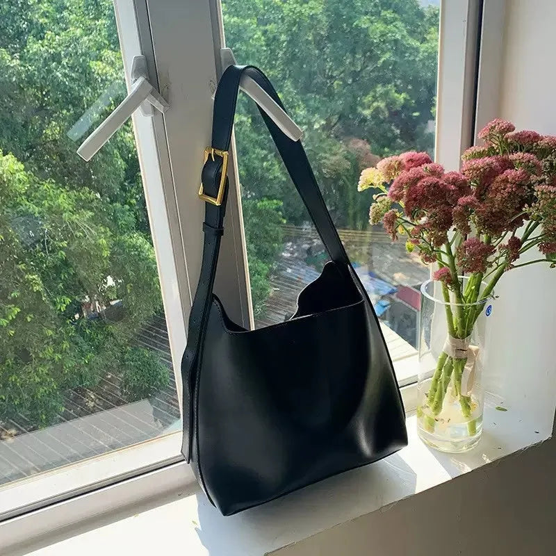 Women's soft PU leather crossbody bag with swing threads detail showing black ribbon colour option