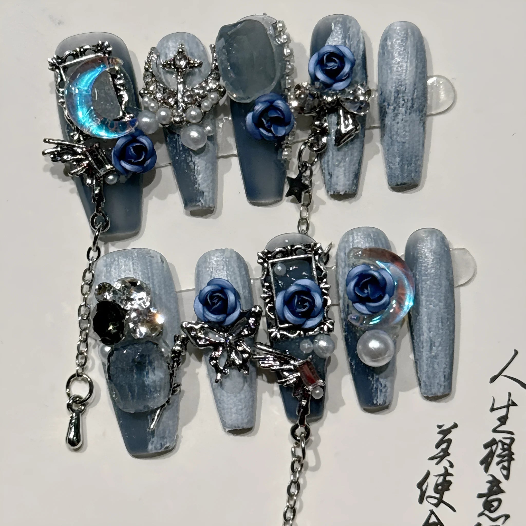 Blue night nail armour with ornate rose and tulip floral patterns in plastic evening manicure set
