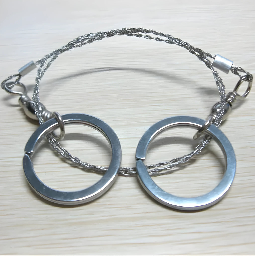 Stainless steel survival wire saw with thumb rings measuring 55cm cutting length