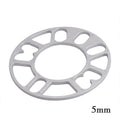Hub centric wheel spacer kit for automotive modification in various thicknesses on a workshop bench.