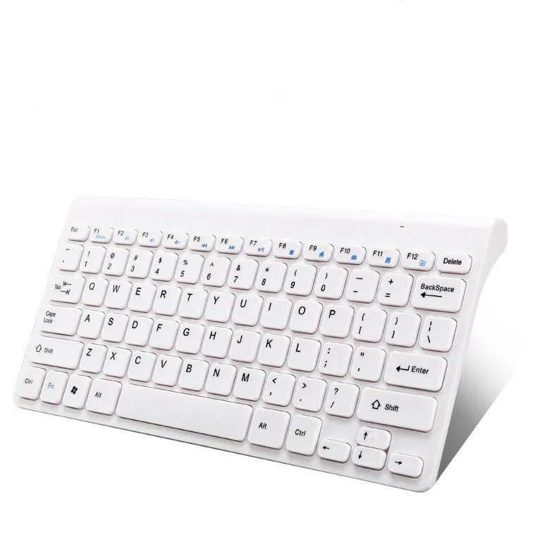 Black and white wireless keyboard and mouse set with USB receiver on wooden desk