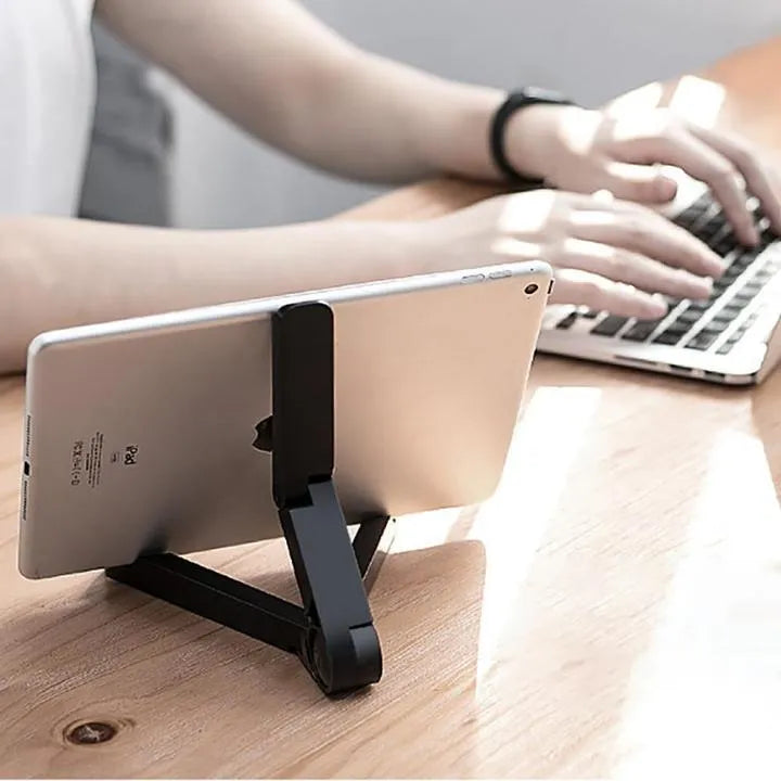 Black foldable tablet holder displaying a smartphone in landscape mode on a desk.