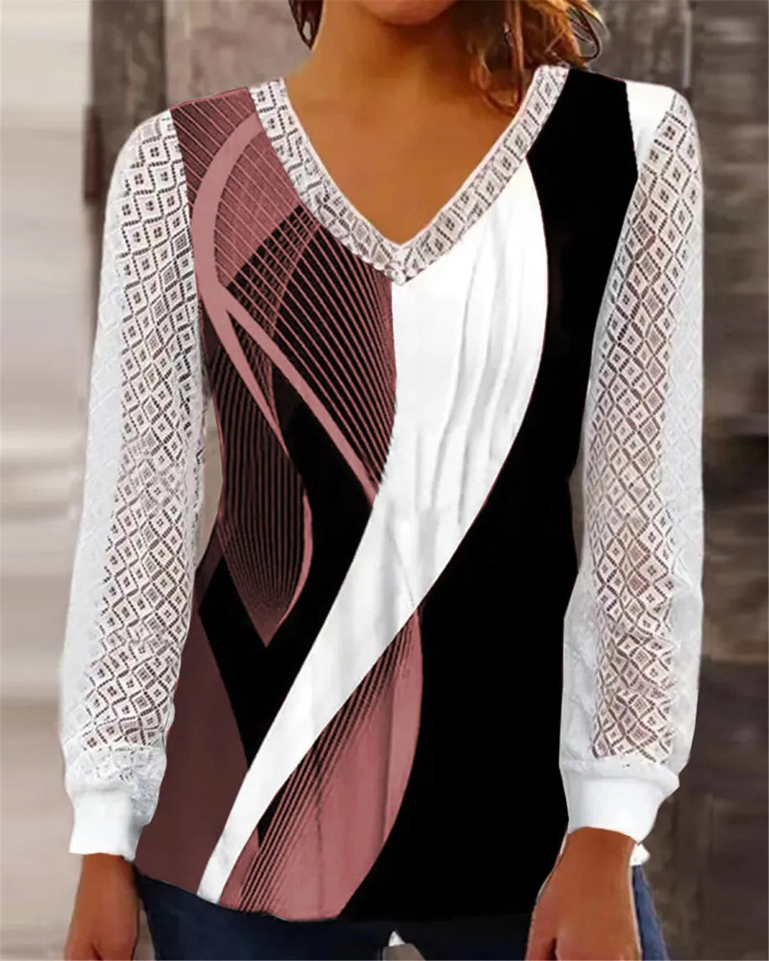 Women's loose V-neck lace top in purple with long sleeves, shown on a hanger.
