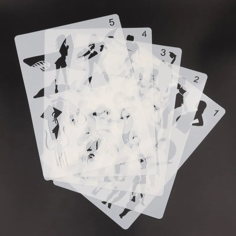 White plastic drawing stencil template for decorative patterns on a craft table.