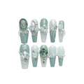 Camellia gradient chain nail art set with diamond, bow and butterfly designs on plastic armour suit