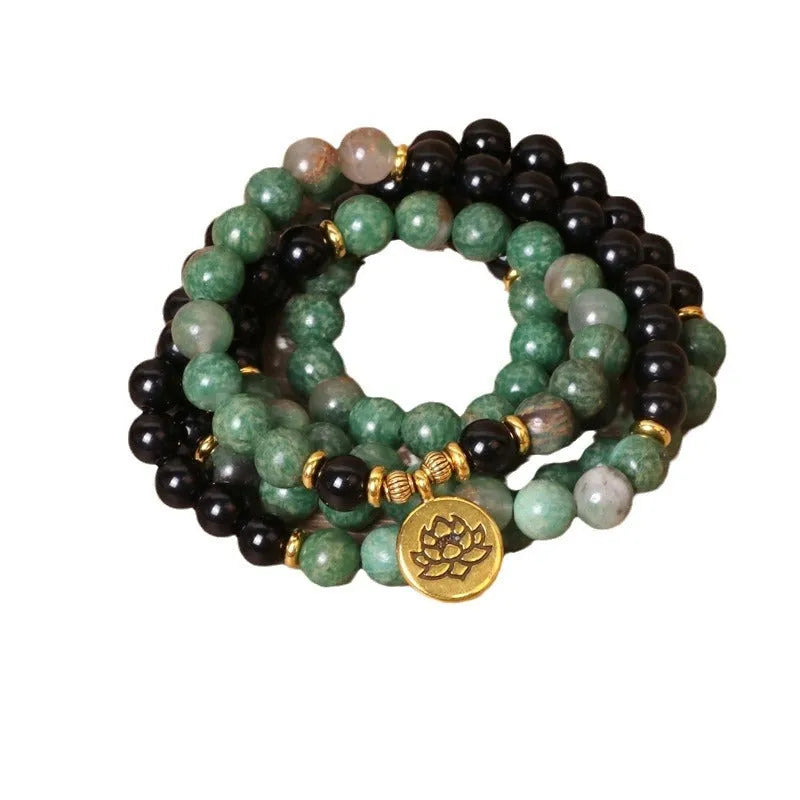 Green and black alloy beaded bracelet on an elastic cord