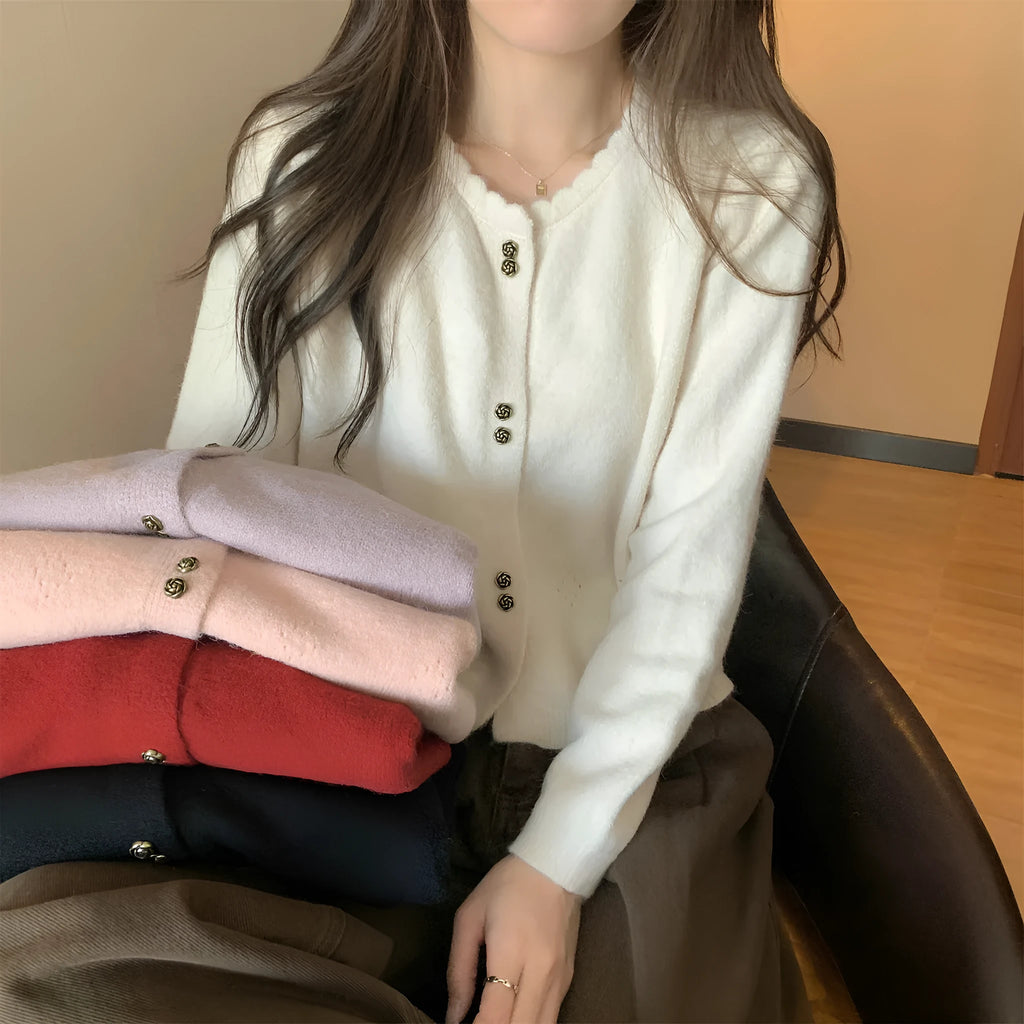 Women's milky white long-sleeved acrylic cardigan coat worn open as a layer.