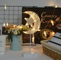 Rattan and PC LED decorative lamp in star, heart, or moon shape on a table.