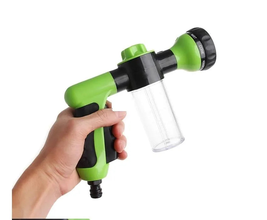 Green high-pressure foam spray gun with adjustable nozzle and attached water hose for car and garden cleaning.