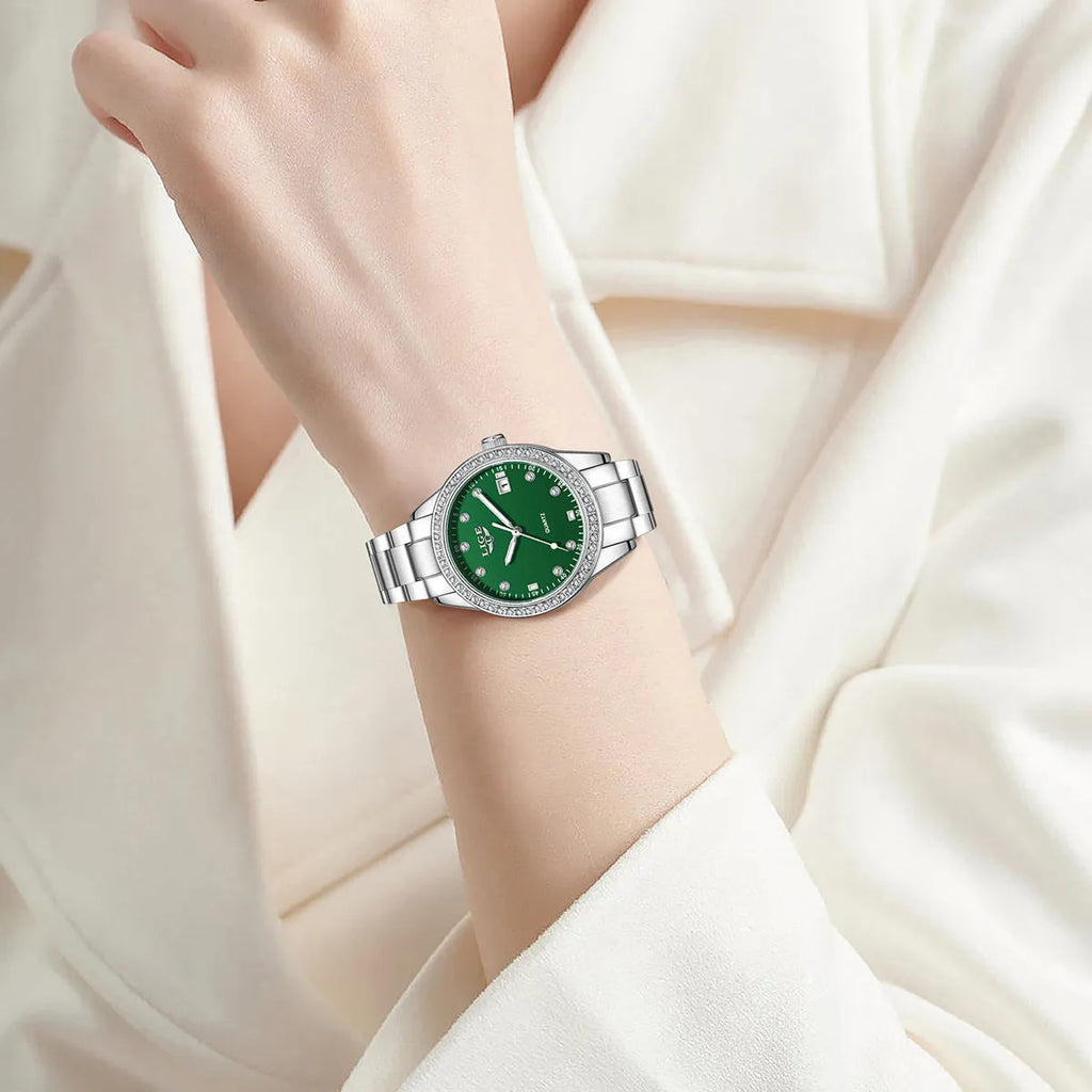 Silver stainless steel women's quartz watch with diamond bezel and luminous hands on a round 34mm dial.