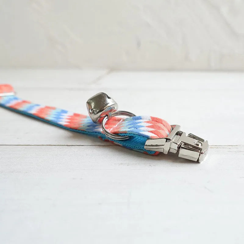 Blue polyester cat collar with printed pattern and lock closure, shown in sizes S and L