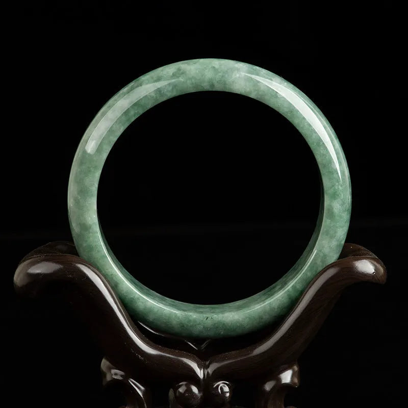 Women's natural emerald bean green ring bracelet on wrist, showing dark pea green beads and gift box.