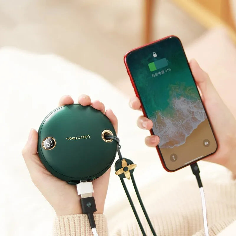 Green hand warmer power bank with digital display showing battery level, next to a charging cable.