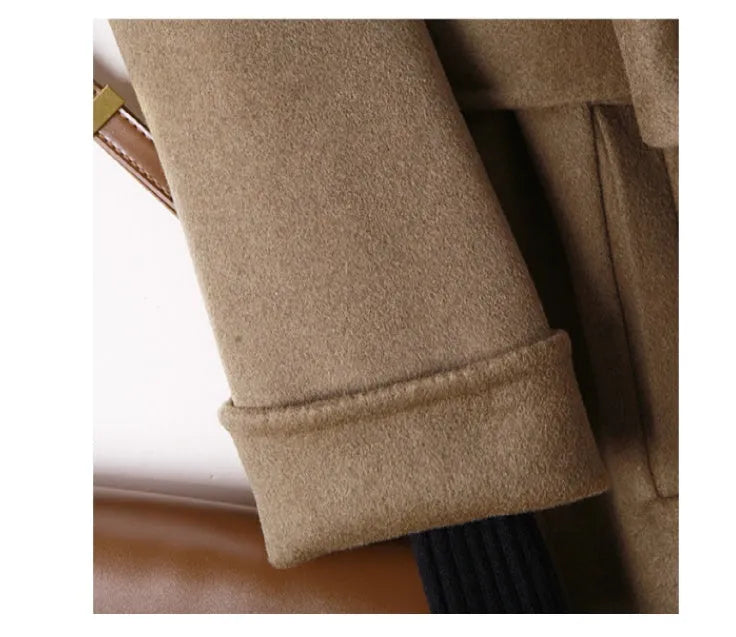 Men's long black wool coat with a suit collar laid flat.