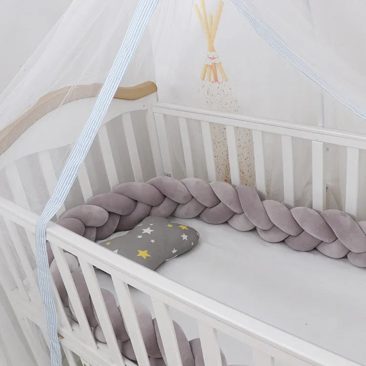 Braided knot baby crib bumper in spandex velvet, shown in light grey colour, flexible and bent to shape.