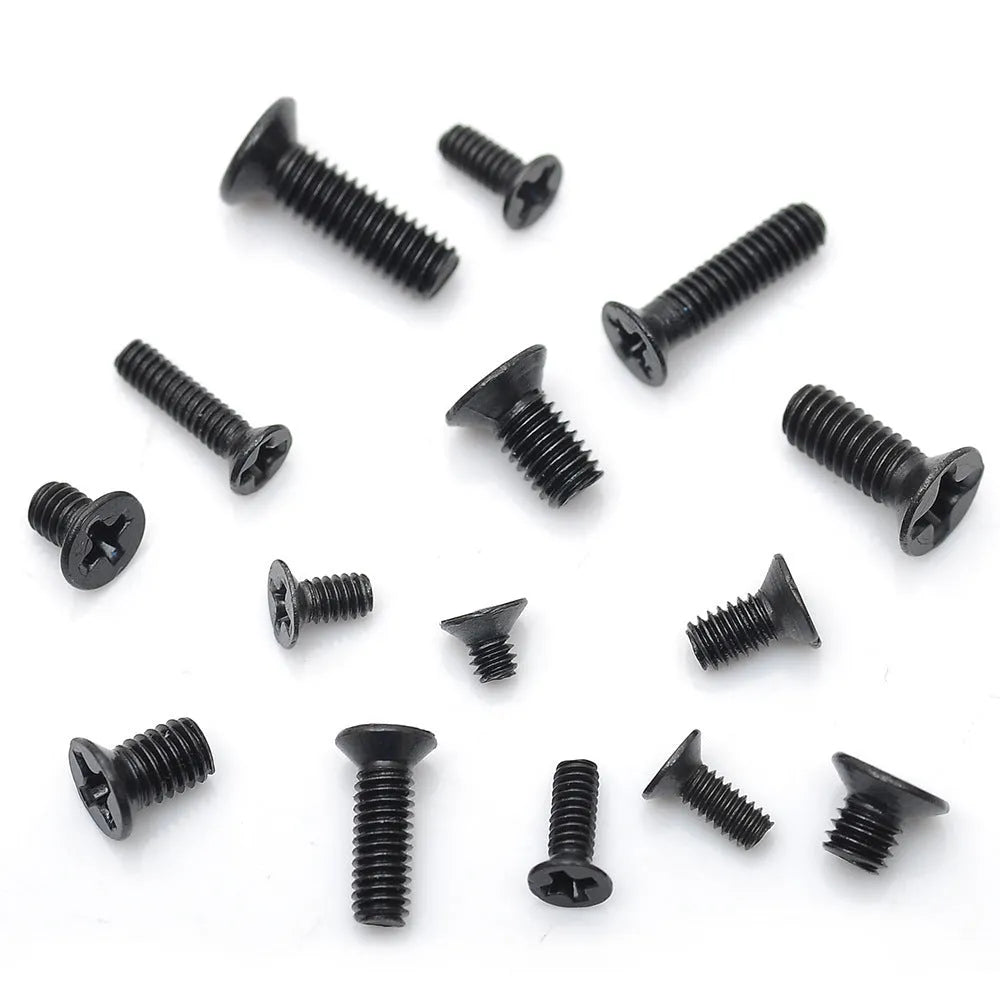 Black laptop machine screws with cross slot countersunk heads, 1.4mm diameter, in a box.