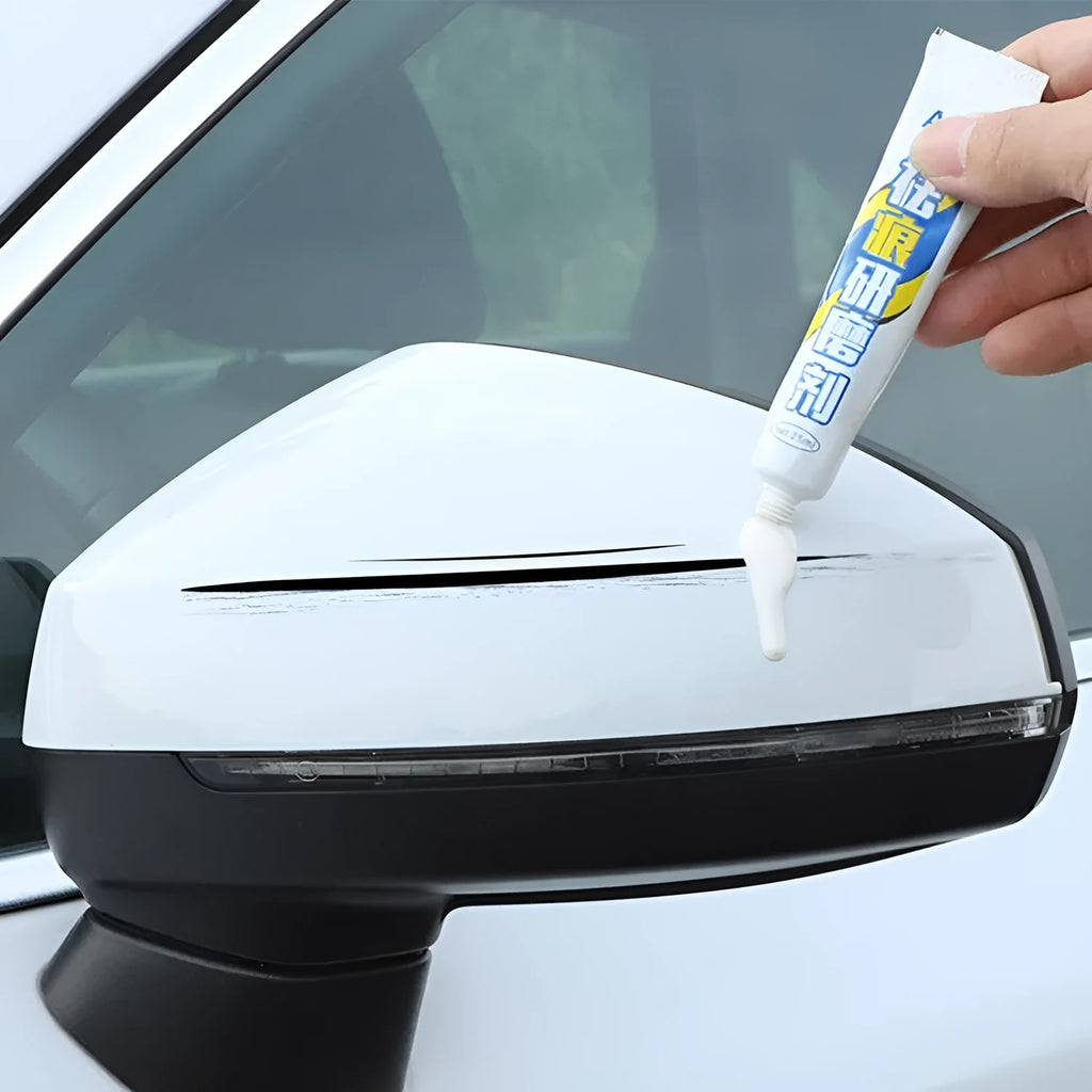 Automotive paint scratch repair kit with touch-up pen, wax, sandpaper, and sponge.