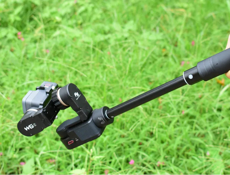 Black retractable selfie stick extended, showing smartphone mounted for a handheld shot.