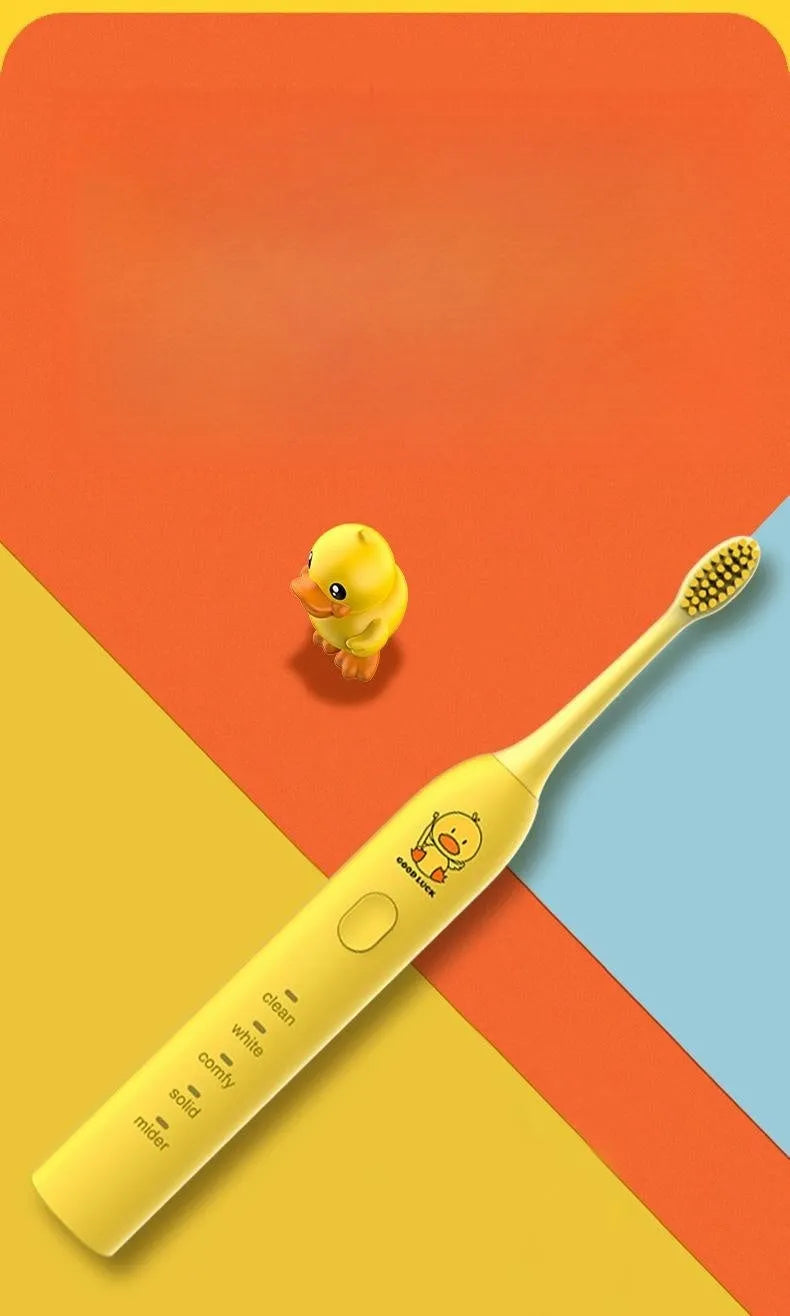 Yellow rechargeable electric toothbrush with soft bristles on a bathroom counter