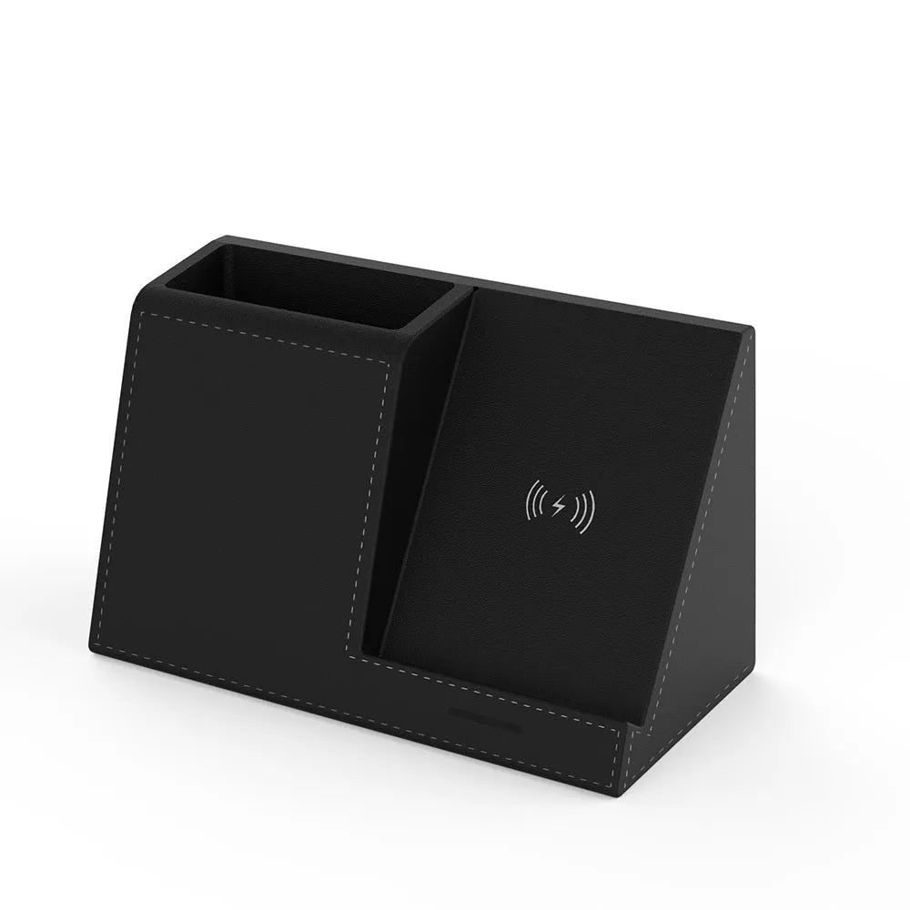 Black leather wireless charging station with built-in pen holder on a wooden desk.