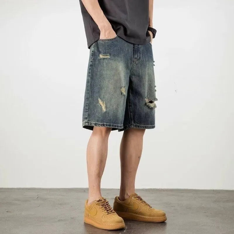 Man wearing blue retro-style loose denim shorts with a straight leg cut.