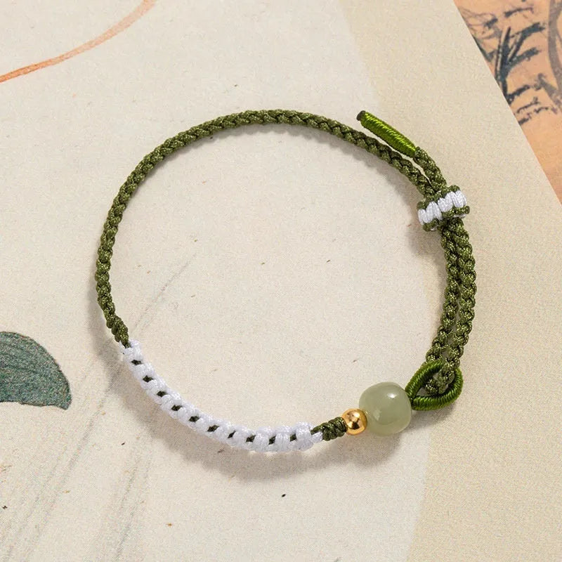 Chinese national bracelet with colourful cord carrying strap and electroplated sterling silver fittings
