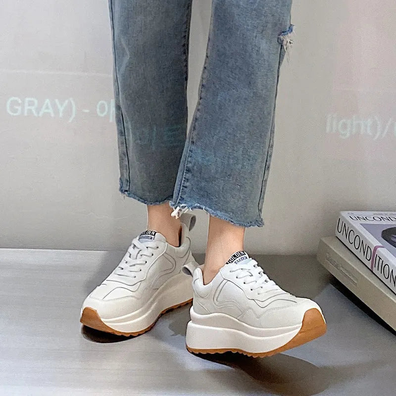 Beige women's low-top lace-up casual shoes with cowhide leather upper and cross strap detail.