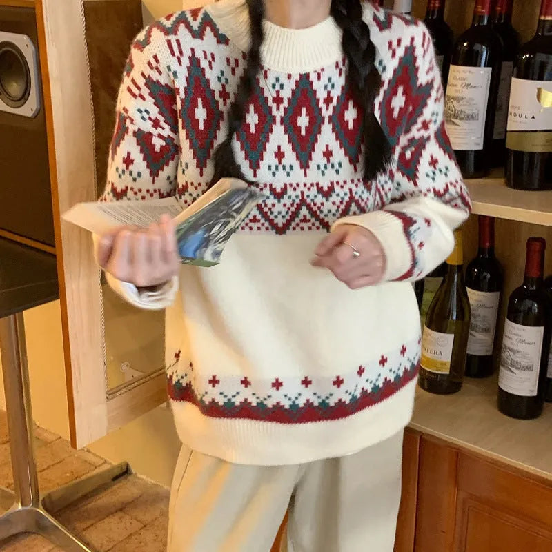 Red and white striped loose fit long sleeve knitted pullover top on a hanger.