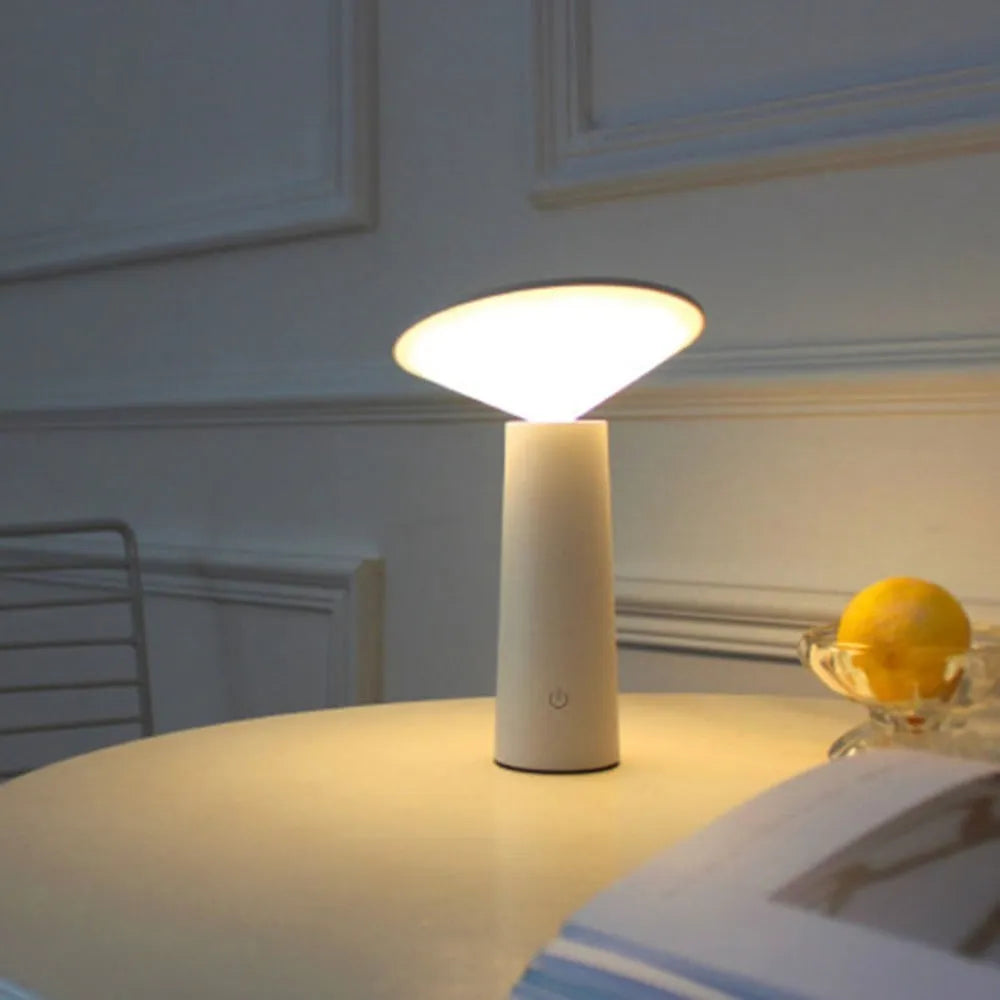 Black USB rechargeable LED desk lamp with touch controls and an adjustable lamp head on a wooden desk