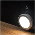 Round white motion sensor LED light unit with PIR sensor and LED array.