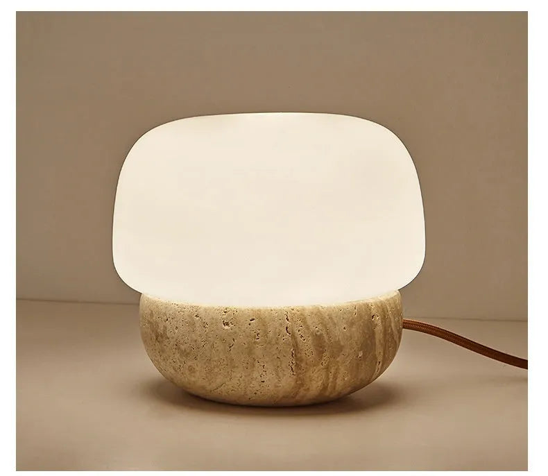 Cream coloured retro bedside lamp with a button switch on a wooden surface.