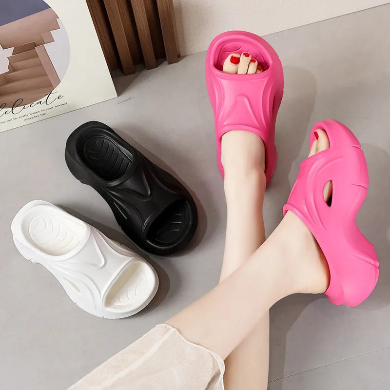Women's white EVA slippers with thick sole and round toe on sandy beach