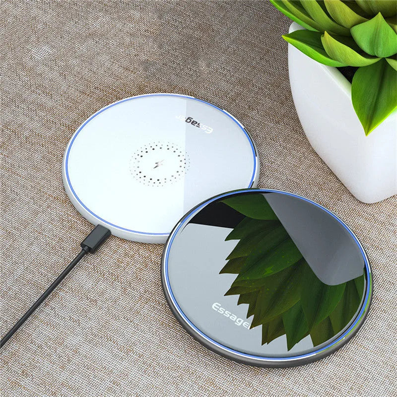 Black or white aluminium alloy wireless charging pad with LED status light on desk.