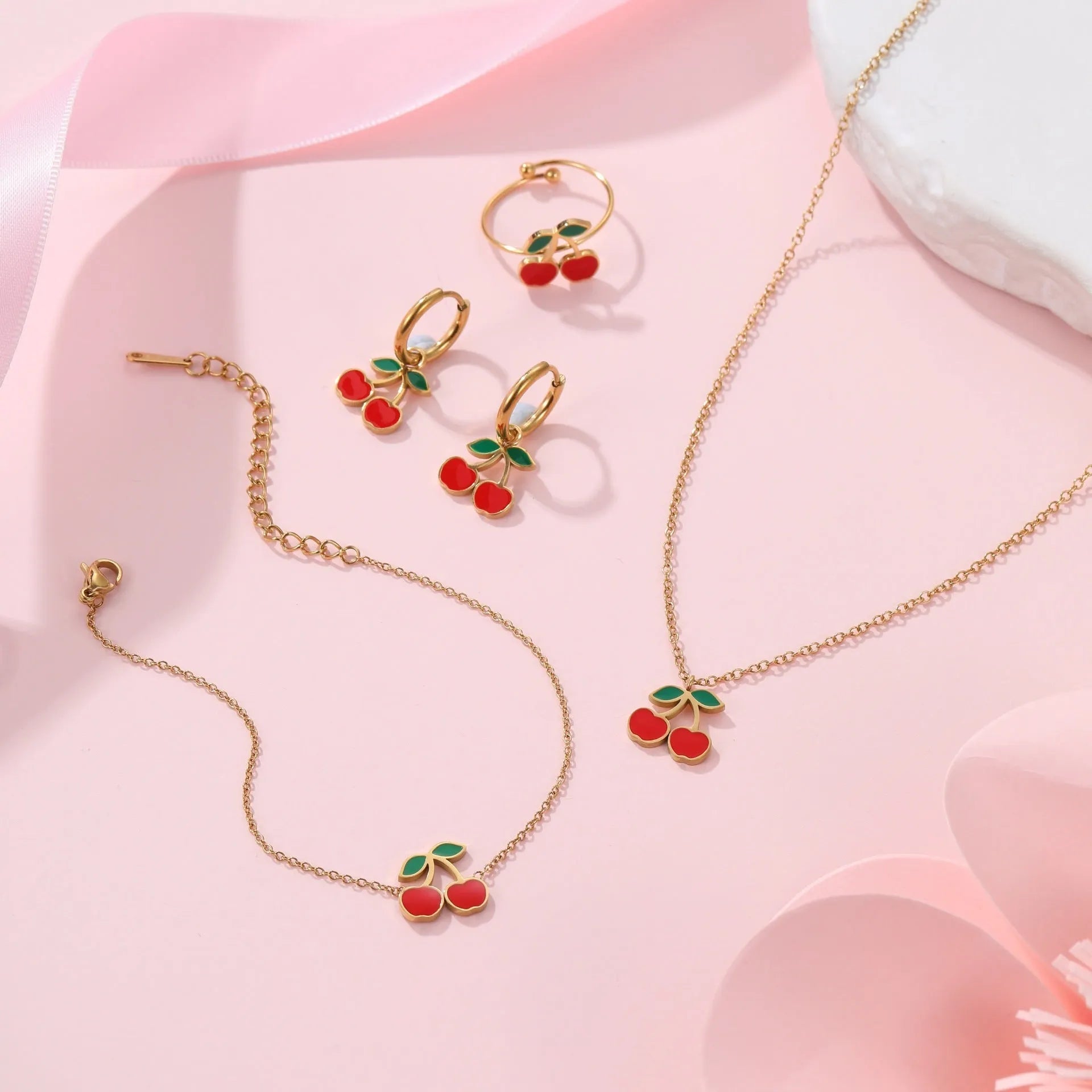 Cherry jewellery set with gold-plated necklace, bracelet, earrings, and ring on stainless steel chain