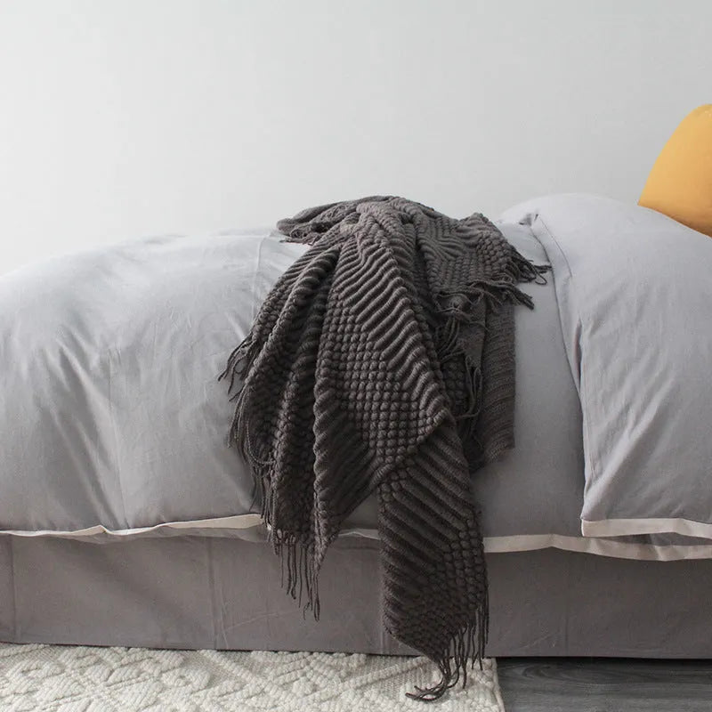 Small light grey polyester nap blanket folded, showing its size of 127 by 170 centimetres.