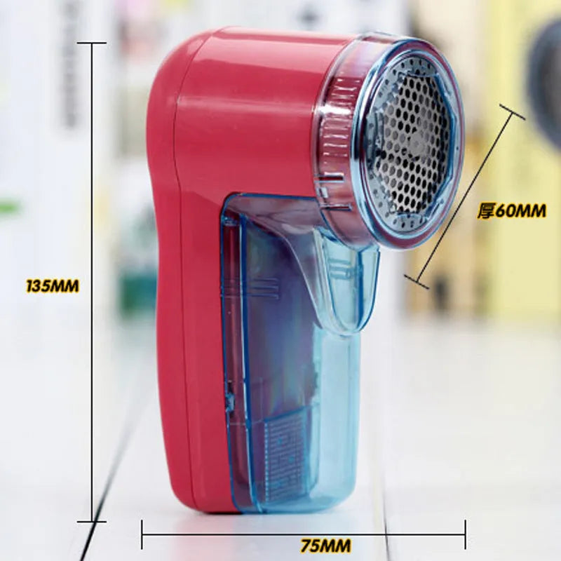 Compact white portable electric lint remover for clothing on a grey background.