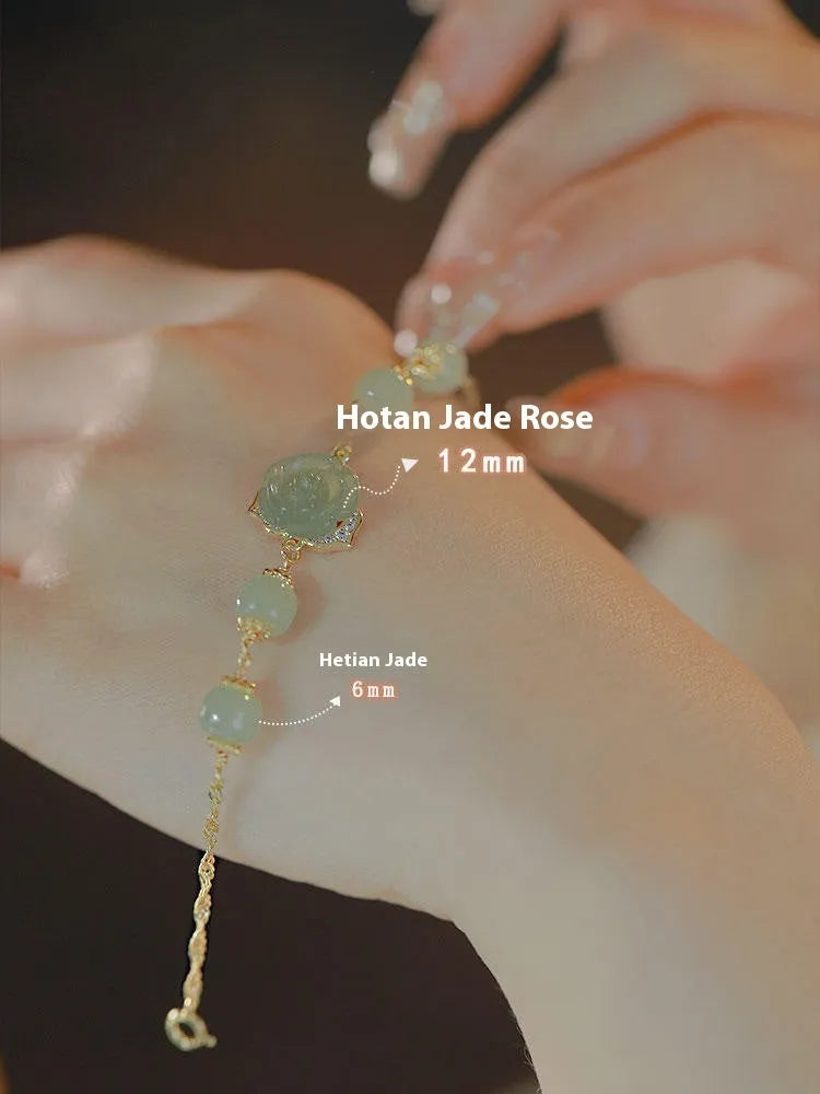 Close-up of a women's bracelet with a handmade Hetian Jade rose flower on a 14K gold plated band.