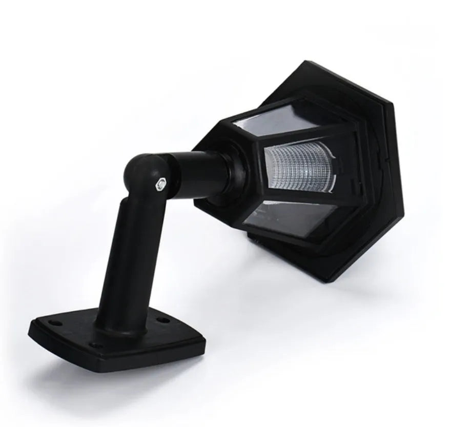 Black hexagonal solar-powered outdoor wall lamp with LED light.