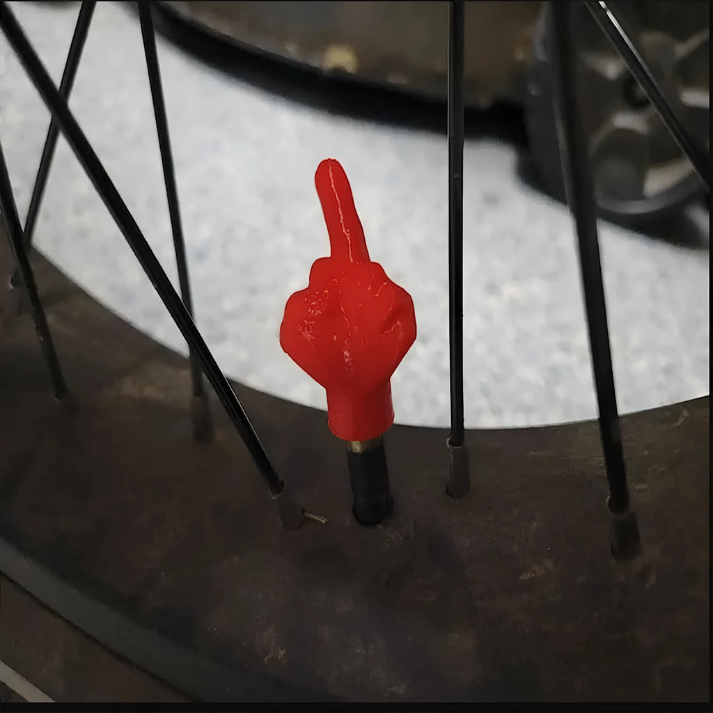Four latex tyre valve dry caps showing black and skin tone finishes for car wheel protection
