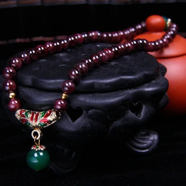 Natural garnet bracelet with 7mm beads, double ring closure and golden toad charm
