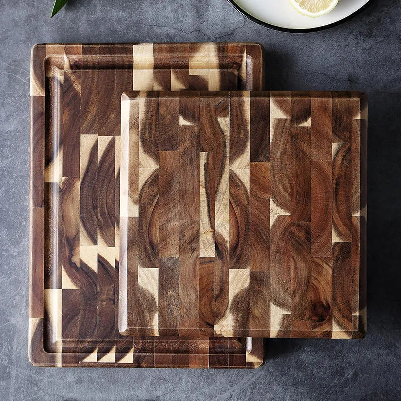Brown acacia solid wood parquet cutting board with 3cm thickness on a kitchen counter.