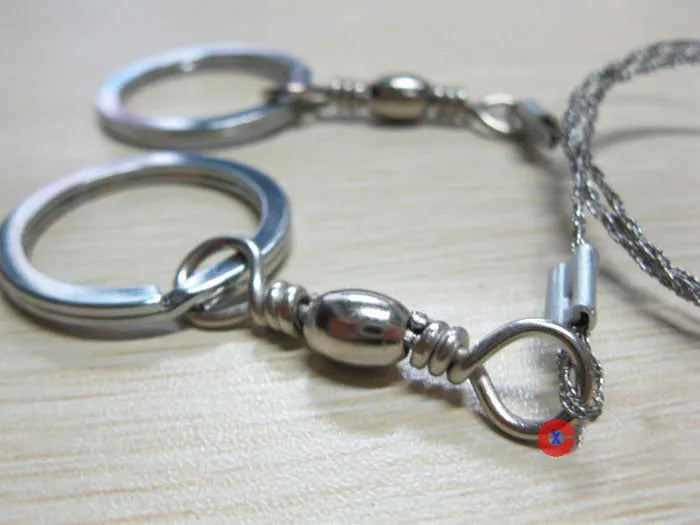 Stainless steel survival wire saw with thumb rings measuring 55cm cutting length