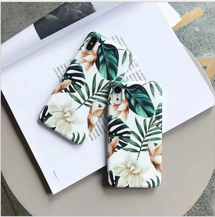 Soft TPU iPhone case with green banana leaf and pink floral art design on a white background.